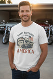 Man wearing a white t-shirt with 'Happy Birthday to You America' design in front of motorcycles.
