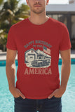 Person wearing a red t-shirt with a graphic design and text, standing by a pool.